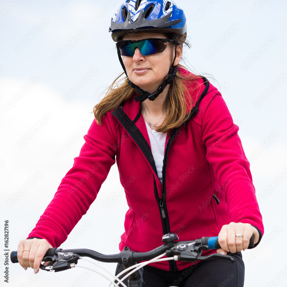 Middle-aged woman riding bicycle Middle-aged woman riding bicycle