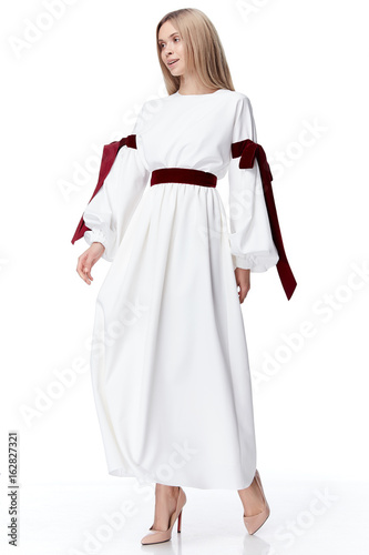 Beautiful sexy pretty fashion model blond hair woman wear style for party office clothes organic natural silk dress strips bow white background makeup lady designer collection. photo