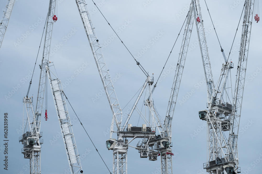Five construction cranes Five construction cranes