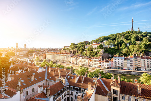 Morning aerial cityscape view with beautiful old buildings and metallic tower on the mountain in Lyon city in France photo