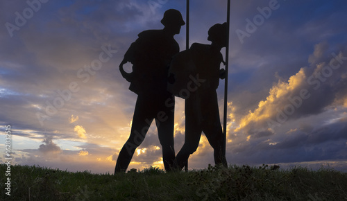 The way of Saint James Alto del Perdon top with steel sculpture of pilgrims at Navarra photo