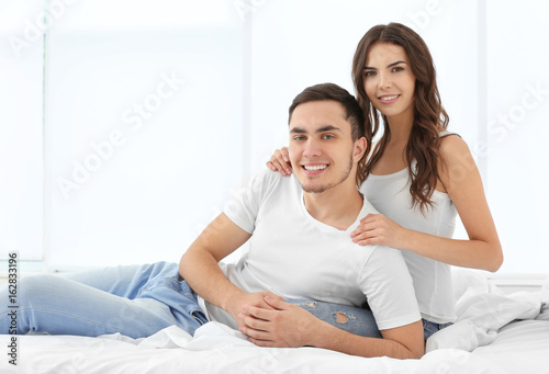 Beautiful couple in bed at home