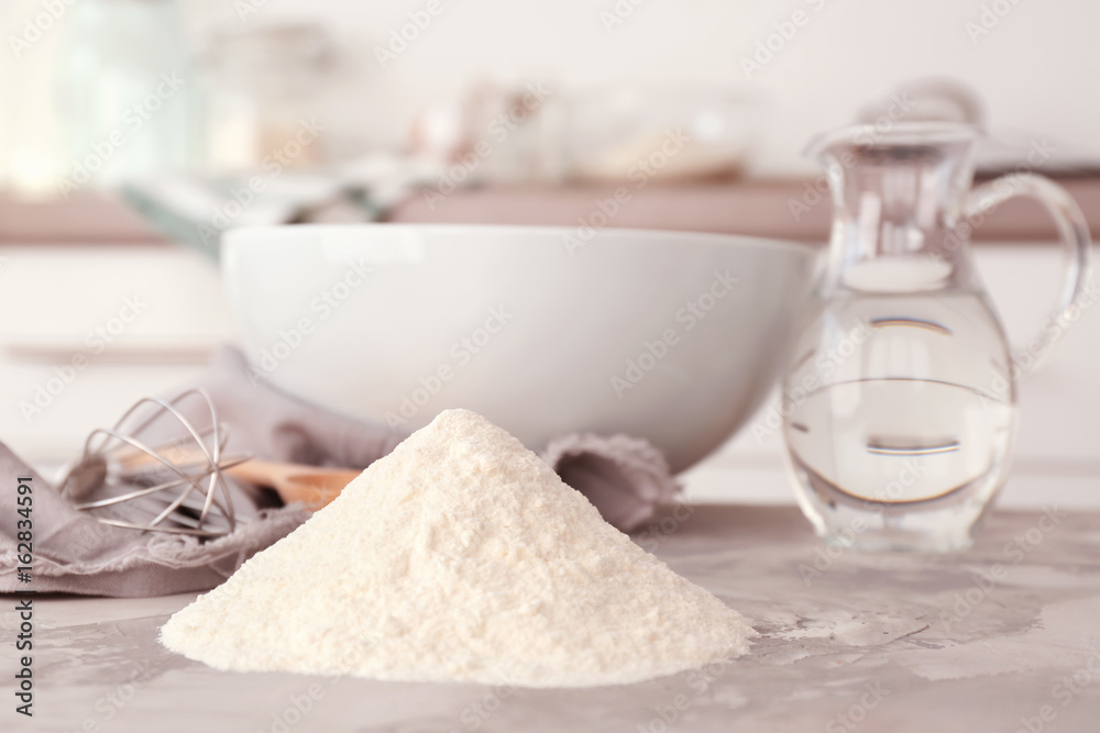 Heap of flour and kitchenware on light table Heap of flour and kitchenware on light table