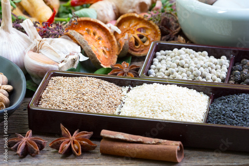 black pepper ,white pepper and ingredient on wood background concept for herb and spices background