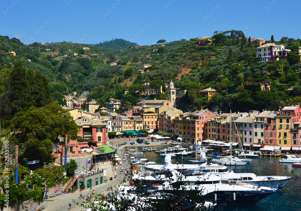 PORTOFINO, ITALY - JUNE 13, 2017: spectacular panorama of Portofino town with its harbour with yachts and boats, Portofino, Liguria, Italy