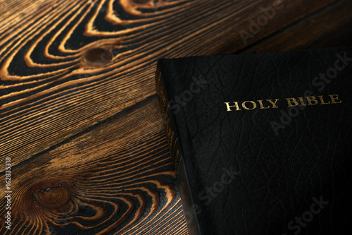 Photo The Bible on the old wooden table, top view