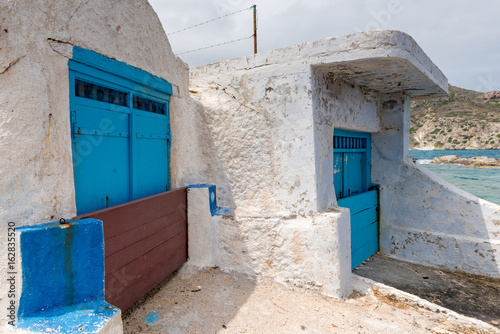Typical boat houses (sirmata) in Mandrakia village on Milos island. Cyclades, Greece. © vivoo