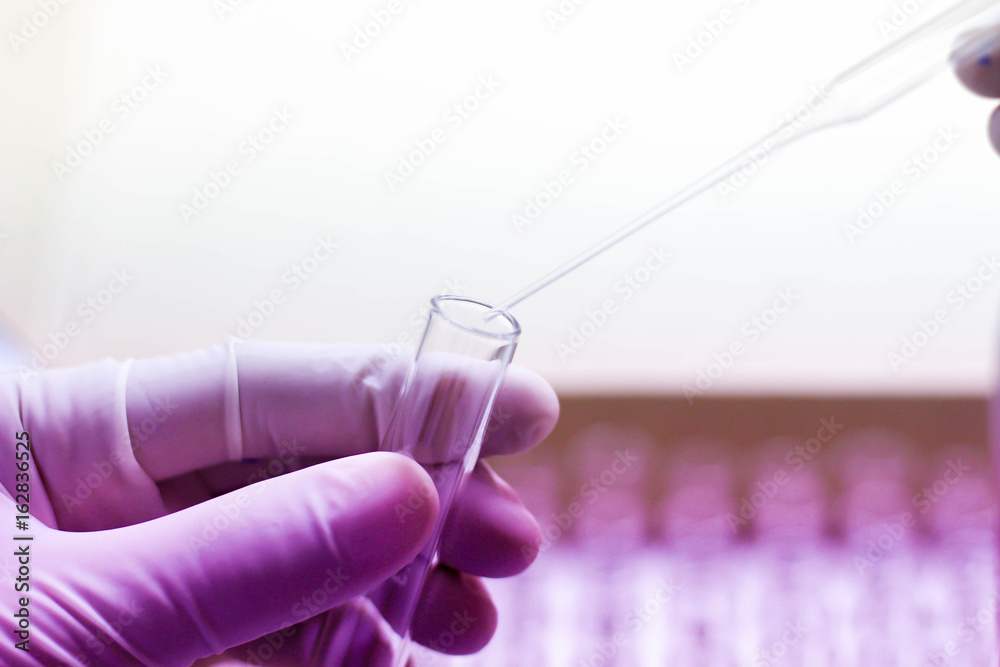 close upscientist working with test tubes in chemical lab