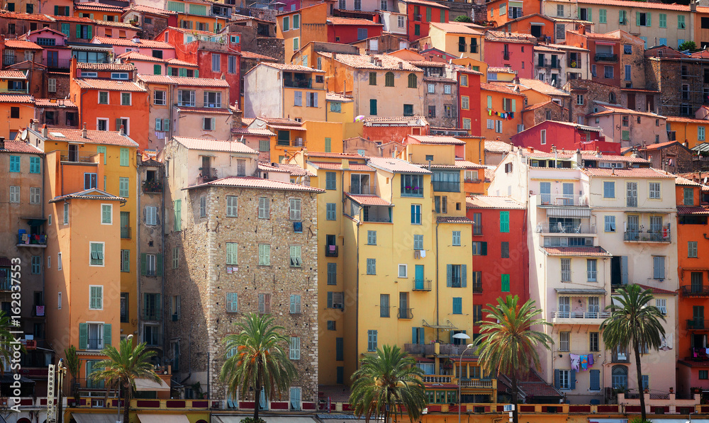 facades of colorful houses of Menton old town, France, retro toned