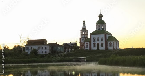 Fog moving above the surface of Kamenka river in front of Ilyinskaya Church in the evening in Suzdal, Vladimir oblast, Russia
