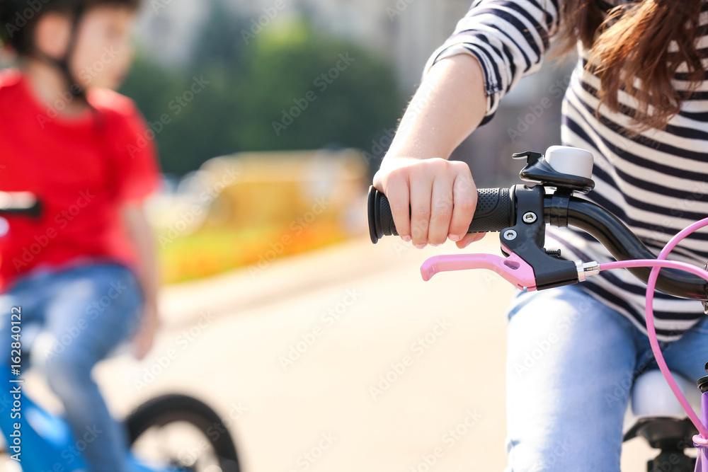 Cute little child riding bicycle outdoors on sunny day, closeup Cute little child riding bicycle outdoors on sunny day, closeup