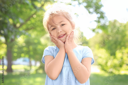 Cute little girl in park on...