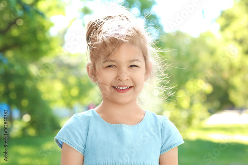 Cute little girl in park on...