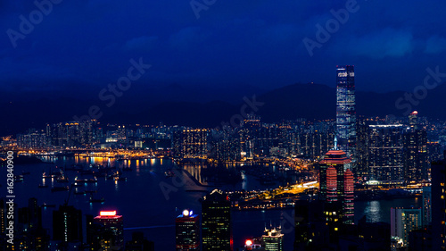 Hong Kong iconic night view from Victoria peak, Beautiful light illuminate skyscraper © glowonconcept