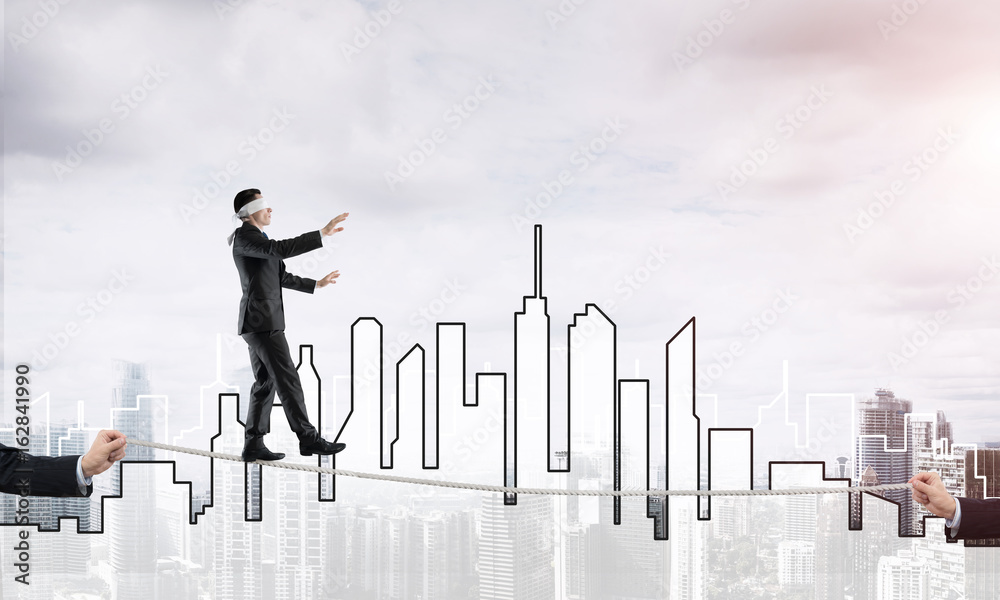 Business concept of risk support and assistance with man balancing on rope Business concept of risk support and assistance with man balancing on rope