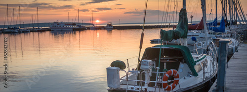 sailboats at sunrise in marina
