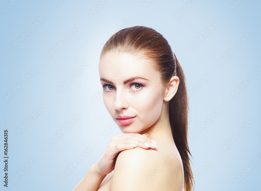 Portrait of young, beautiful and healthy woman: over blue background. Healthcare, spa, makeup and face lifting concept. Portrait of young, beautiful and healthy woman: over blue background. Healthcare, spa, makeup and face lifting concept.