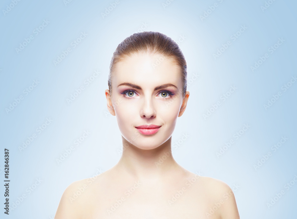 Portrait of young, beautiful and healthy woman: over blue background. Healthcare, spa, makeup and face lifting concept. Portrait of young, beautiful and healthy woman: over blue background. Healthcare, spa, makeup and face lifting concept.