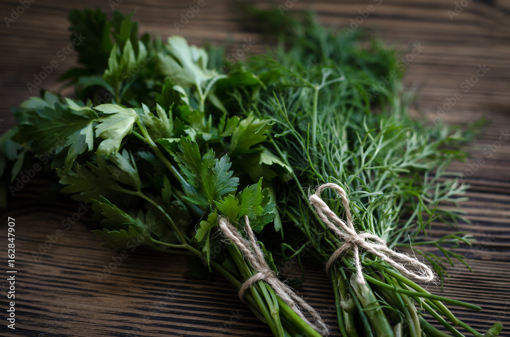 Fresh green dill and parsley herbs on rustic wooden table. Top view with copy space Fresh green dill and parsley herbs on rustic wooden table. Top view with copy space