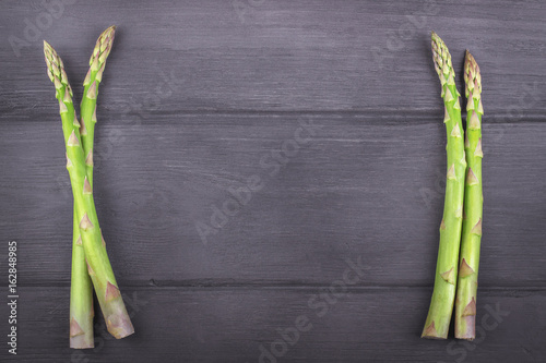 Fresh asparagus on wooden rustic background. Copy space