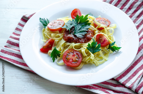 Pasta with sauce made of tomatoes, parsley, and basil