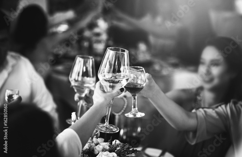 People clink glasses with wine after toast at the party
