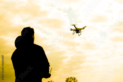 A man with a quadrocopter in his hands. White kvadrokopter prepare for flight photo
