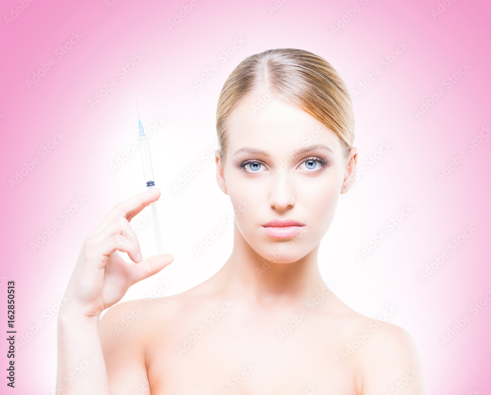 Young, beautiful and healthy woman having skin injections over pink background. Plastic surgery concept. Young, beautiful and healthy woman having skin injections over pink background. Plastic surgery concept.