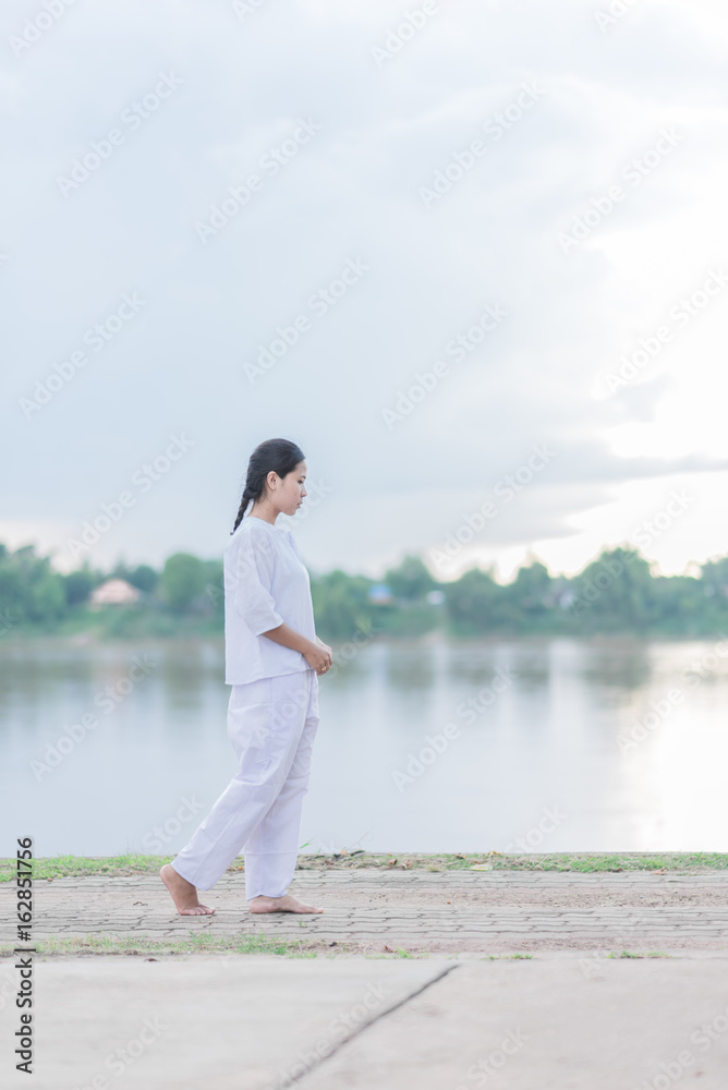 Buddhist Nuns meditation walking in the temple of thailand. Buddhist Nuns meditation walking in the temple of thailand.