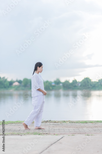 Buddhist Nuns meditation walking in the temple of thailand.