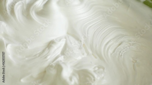 Kitchen mixer whips cream custard pastry whisk rotates rapidly. Food processor beat the eggs white egg whites into a thick foam. Kitchen machine in operation.
