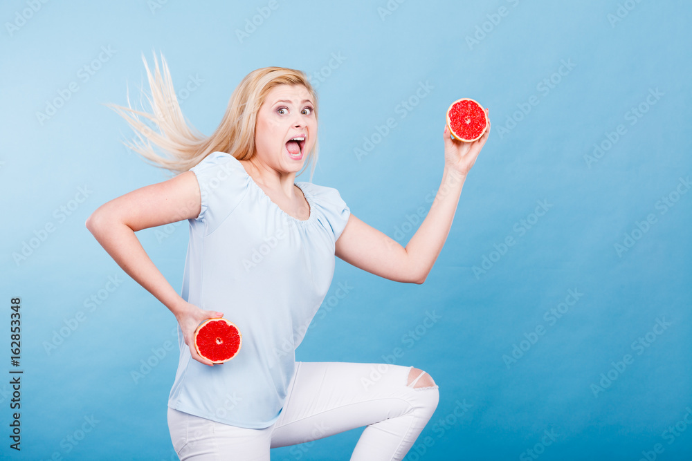 Woman holding red grapefruit Woman holding red grapefruit