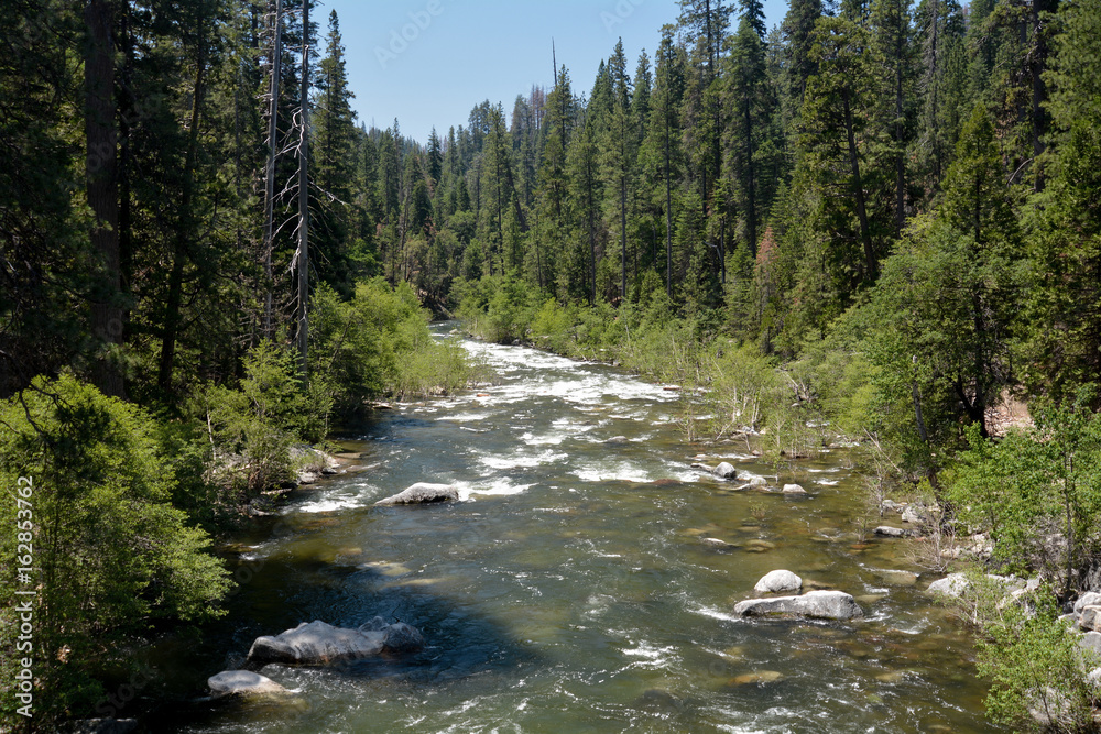 North Fork of the Stanislaus River passing through Calaveras Big Trees State Park, California, USA, on a clear sky day, viewed from a bridge North Fork of the Stanislaus River passing through Calaveras Big Trees State Park, California, USA, on a clear sky day, viewed from a bridge