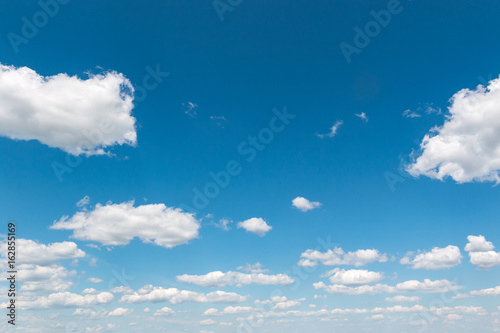 White fluffy big clouds against blue sky