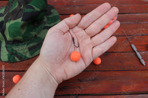 protein balls on hand and hook for fishing bait and lure like carp fish photo