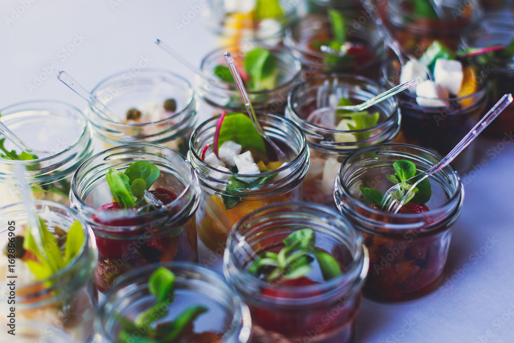 Decorated catering banquet table with different food appetizers assortment on a party
Decorated catering banquet table with different food appetizers assortment on a party