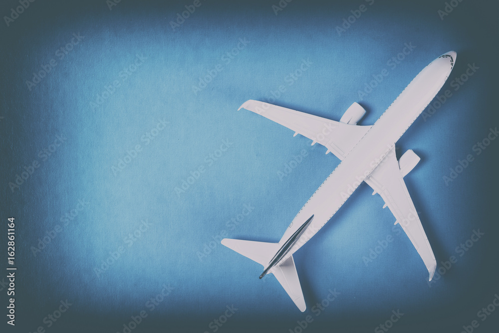 Model of passenger plane on blue background
