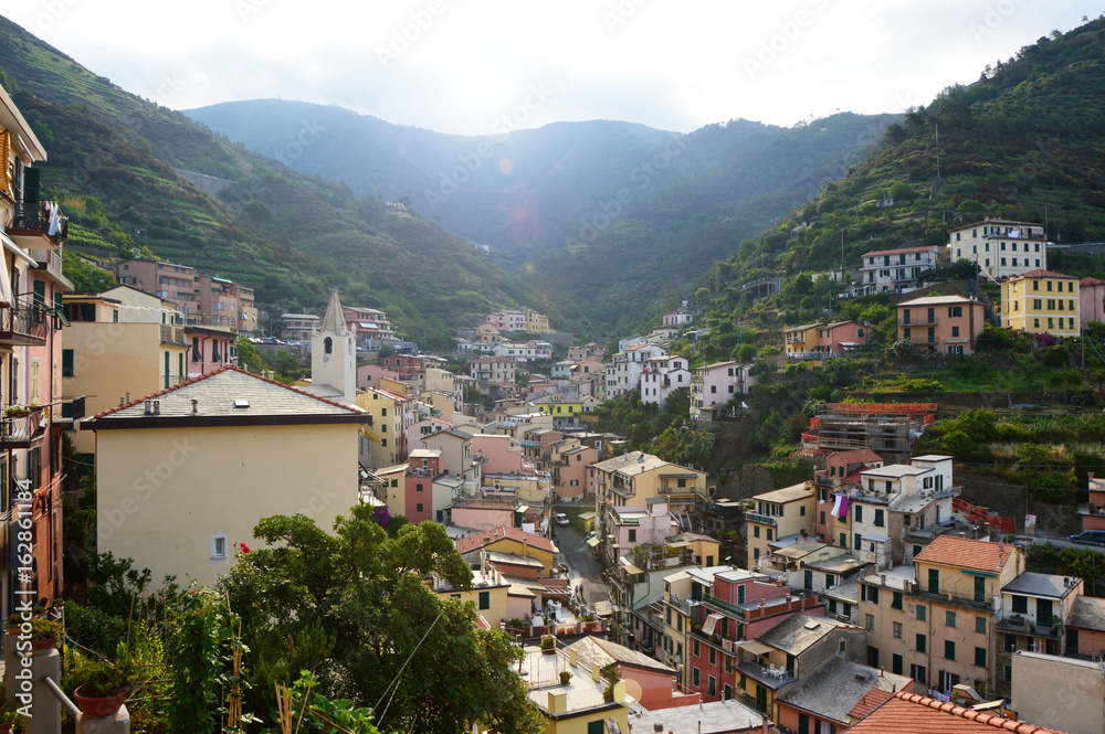 Panoramic view from the center of Riomaggiore with mountains on the background, Riomaggiore, Cinque Terre, Italy