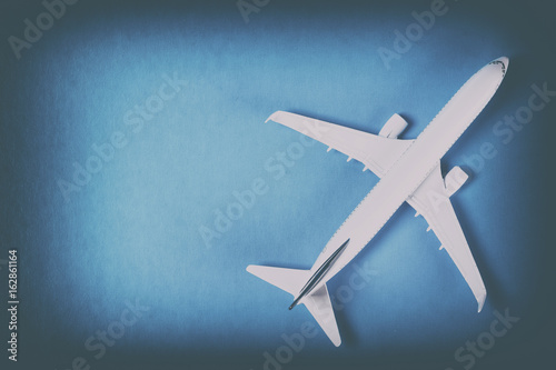 Model of passenger plane on blue background