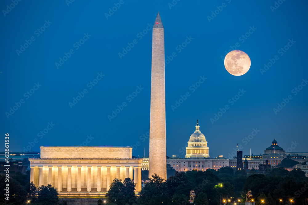 Supermoon above three iconic monuments: Lincoln Memorial, Washington Monument and Capitol Building in Washington DC as viewed from Arlington, Virginia - obrazy, fototapety, plakaty 