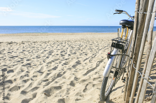 bicycle parked on the sand of the Beach
