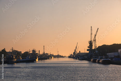 LIEPAJA, LATVIA - JUNE 19, 2017: Sunset at the seaport. Trading channel. Port of Liepaja, Latvia