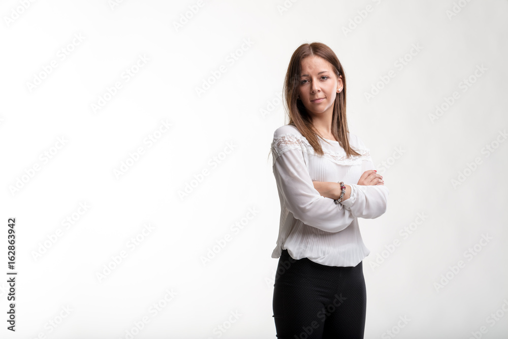 Attractive young businesswoman with folded arms Attractive young businesswoman with folded arms