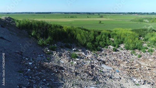 Aerial bird eye view of landfill site drone flying backwards showing the garbage dumped in the waste disposal ready for recycling cyclus by solid waste management program 4k high resolution quality