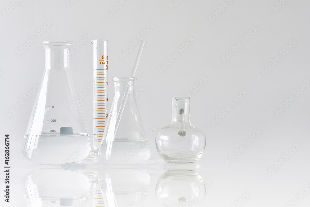 Group of scientific laboratory glassware with clear liquid solution, Research and development concept.