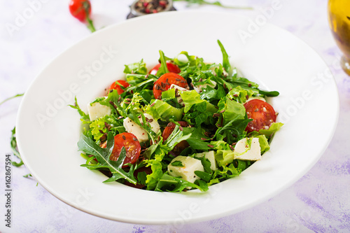 Vitamin Salad of fresh tomatoes, herbs, feta cheese and flax seeds. Dietary menu. Proper nutrition.