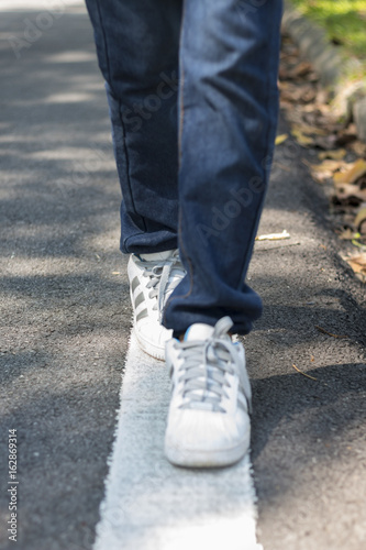Human legs walking on a street