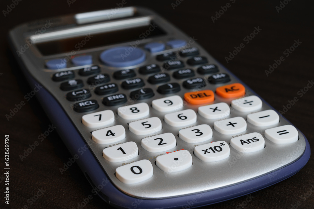 close up advance calculator for engineer or business/finance on the dark brown table table. close up advance calculator for engineer or business/finance on the dark brown table table.