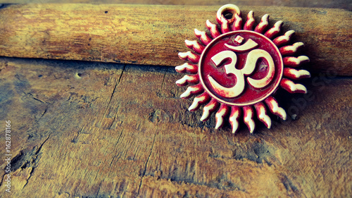 om pendent on wood texture background and greeting 