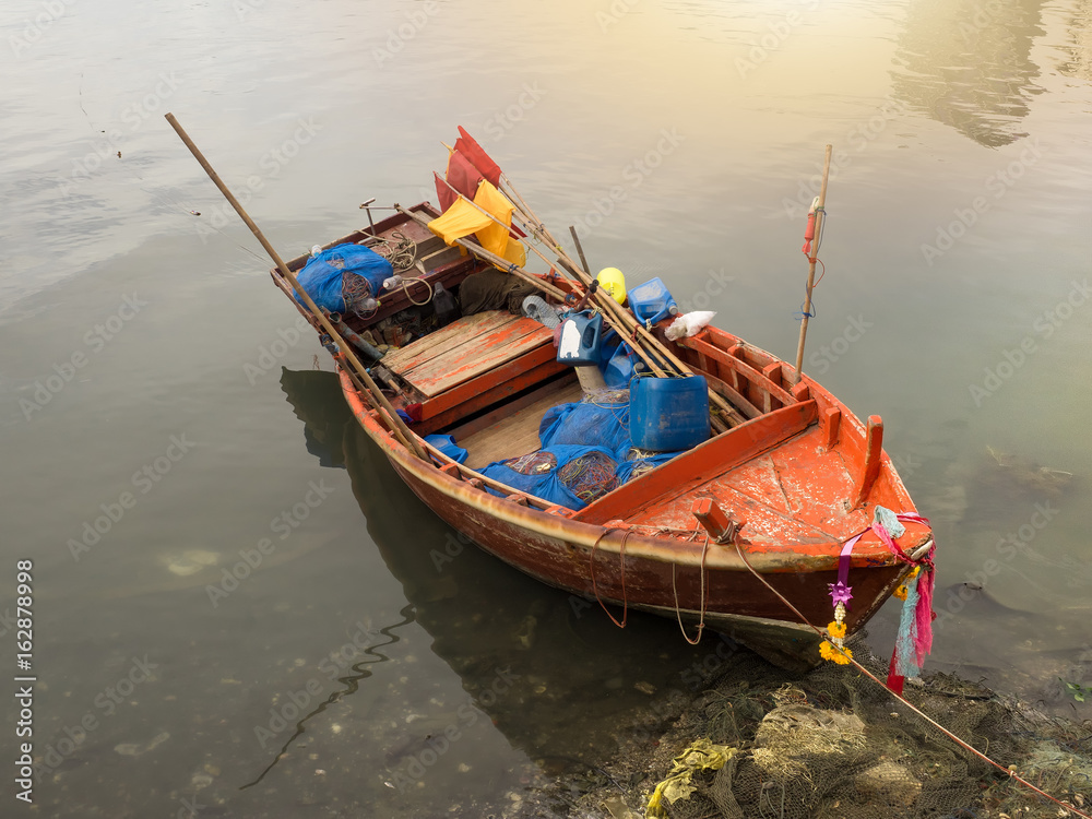 Small wooden fishing boat at old local, Thailand. Stock Photo